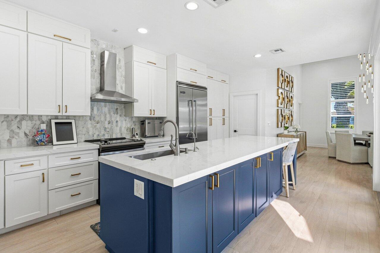 5696 Northwest 39th Avenue Boca Raton, FL 33496 - Photo 5 of 24 a kitchen with a sink stove and cabinets