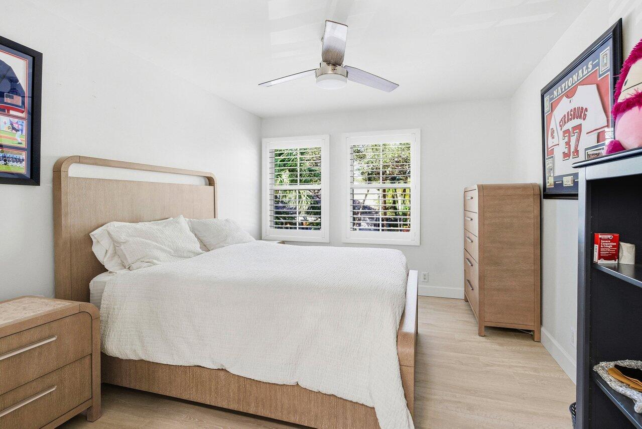 5696 Northwest 39th Avenue Boca Raton, FL 33496 - Photo 10 of 24 a bed sitting in a bedroom next to a window