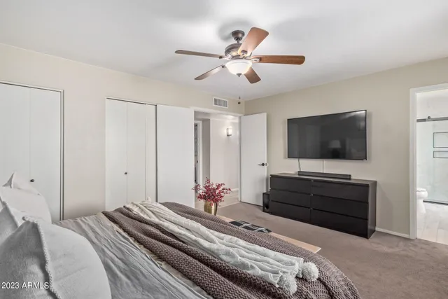 a bedroom with a bed and a flat screen tv