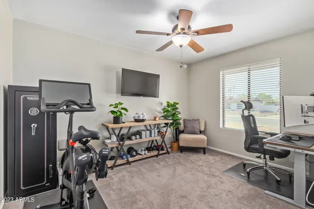 a view of a livingroom with workspace and a window