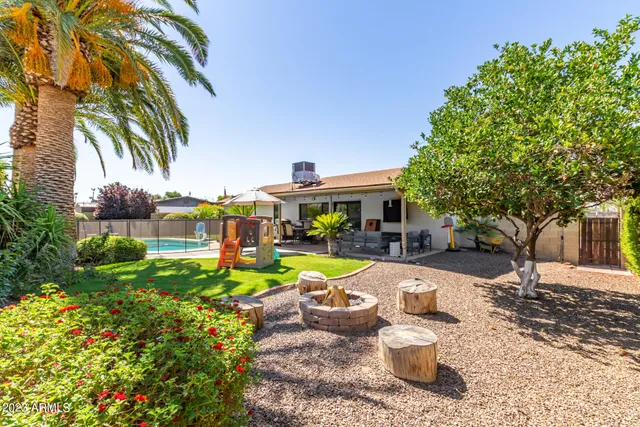 a view of a patio with couches table and chairs and potted plants