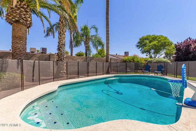 a view of a backyard with swimming pool