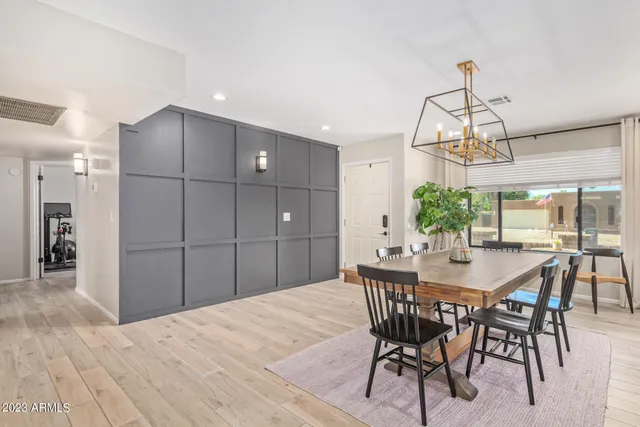 a dining room with a wooden table and chairs