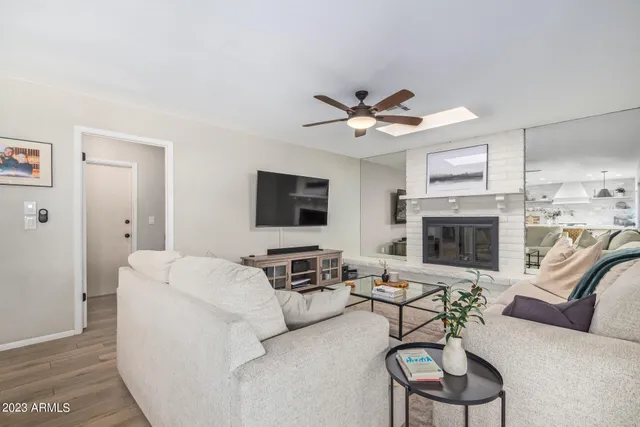 a living room with furniture a fireplace and a flat screen tv