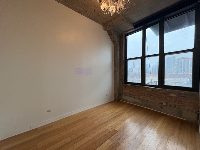 320 East 21st Street, Unit 405 Chicago, IL 60616 - Photo 11 of 15 a view of an empty room with wooden floor and a window