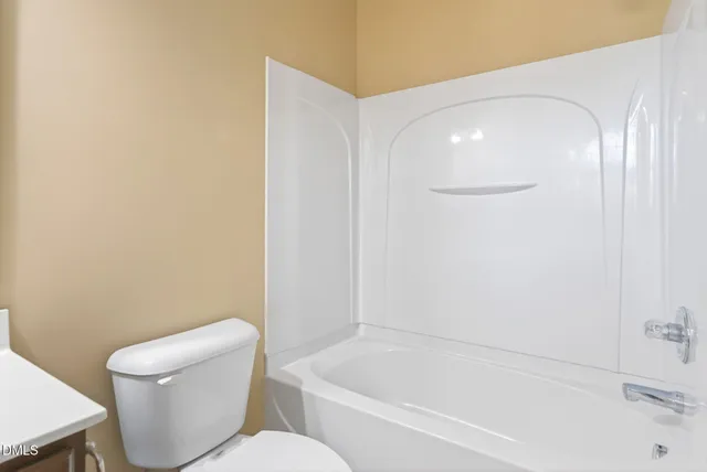 a bathroom with a toilet and bathtub
