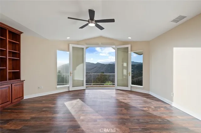 a view of an empty room with a fan