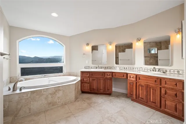 an empty room with windows and fireplace