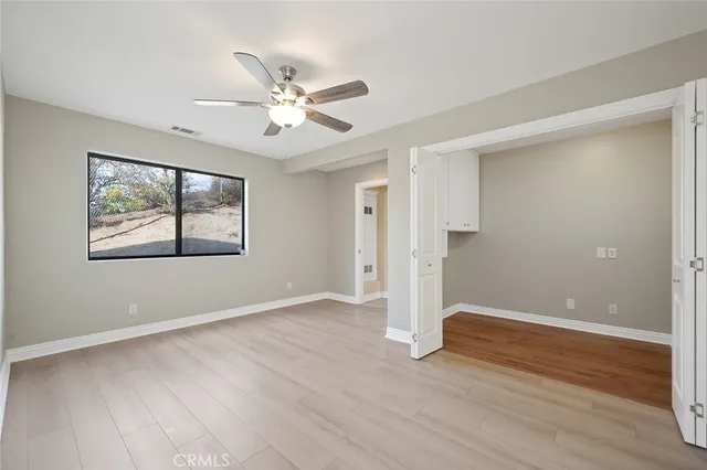 a view of house with backyard and a tree