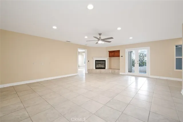 a view of a dry yard with wooden fence