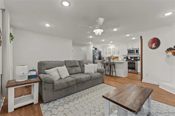 a living room with furniture and kitchen view