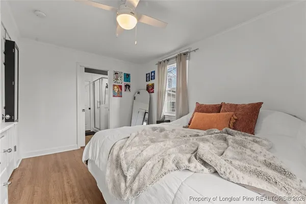 a bedroom with a large bed and a chandelier