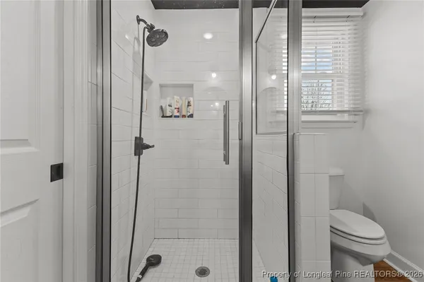 a bathroom with a shower a toilet and a sink