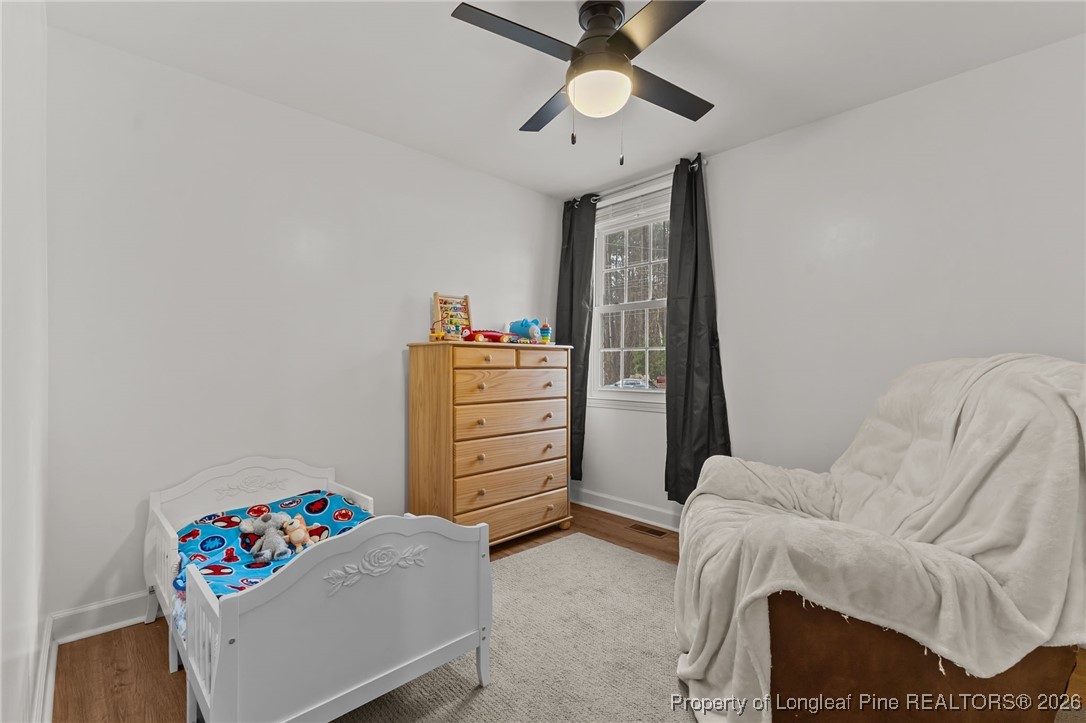 2060 Wade-Stedman Road Stedman, NC 28391 - Photo 23 of 41 a bedroom with a bed and ceiling fan