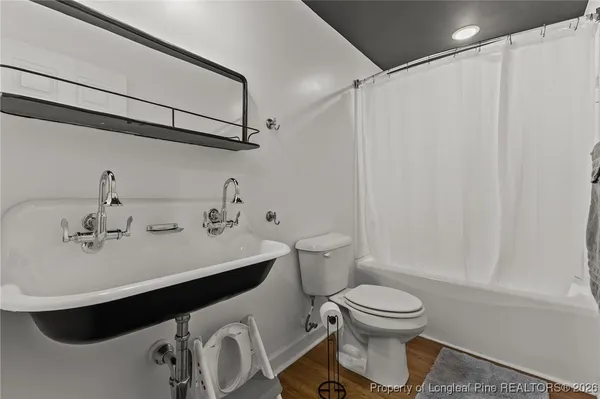 a bathroom with a sink toilet and mirror