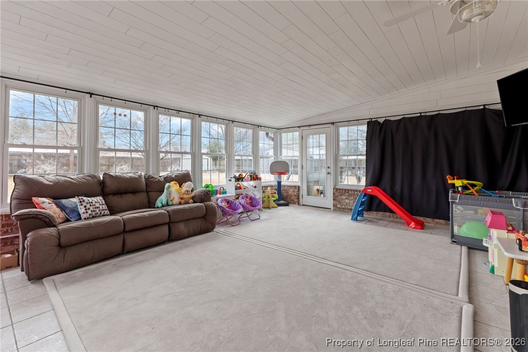 2060 Wade-Stedman Road Stedman, NC 28391 - Photo 27 of 41 a living room with furniture a gym equipment and a flat screen tv