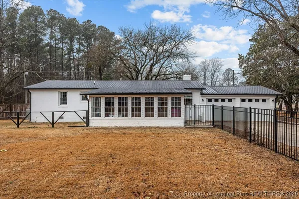 a front view of house with yard outdoor seating and barbeque oven