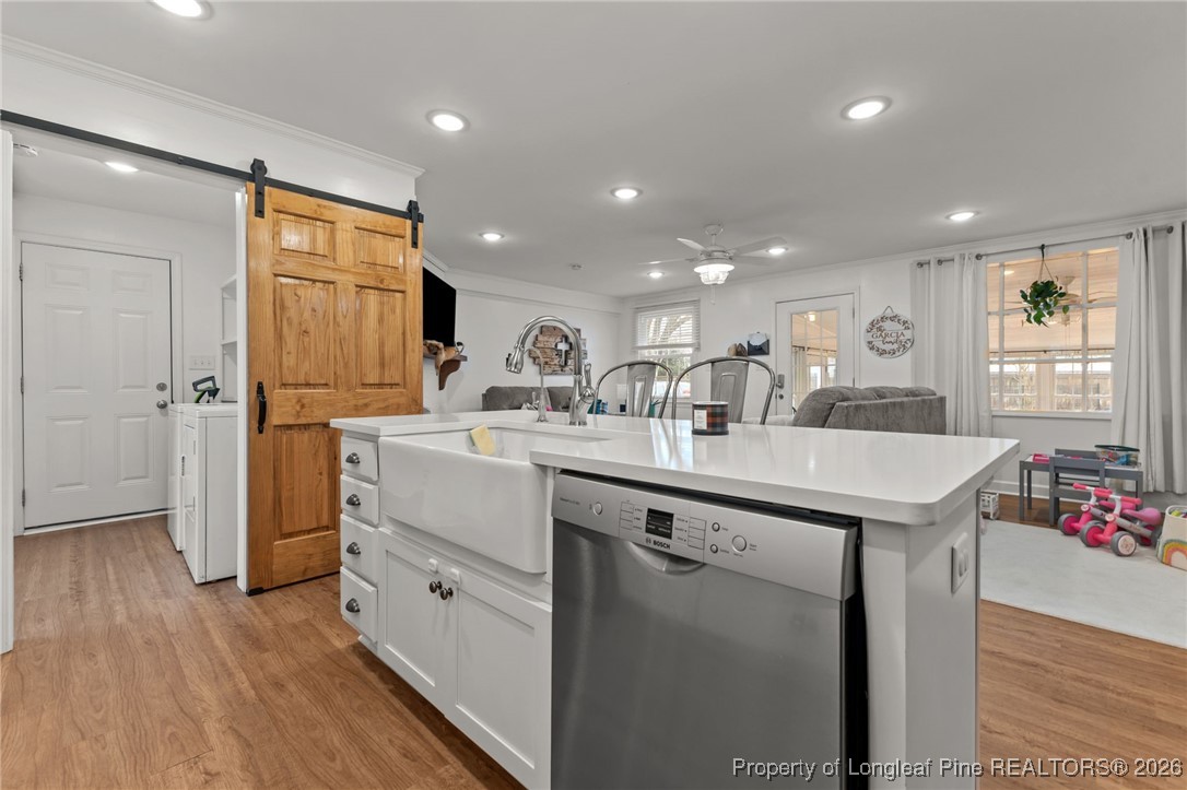 2060 Wade-Stedman Road Stedman, NC 28391 - Photo 7 of 41 a kitchen with kitchen island a sink appliances and cabinets