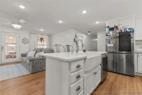 a kitchen with kitchen island a sink stove and refrigerator
