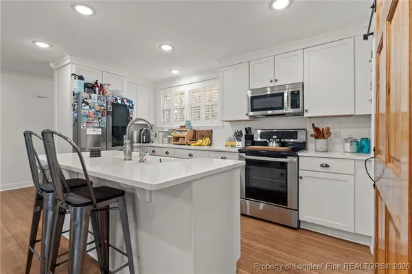 a kitchen with stainless steel appliances a sink stove and refrigerator