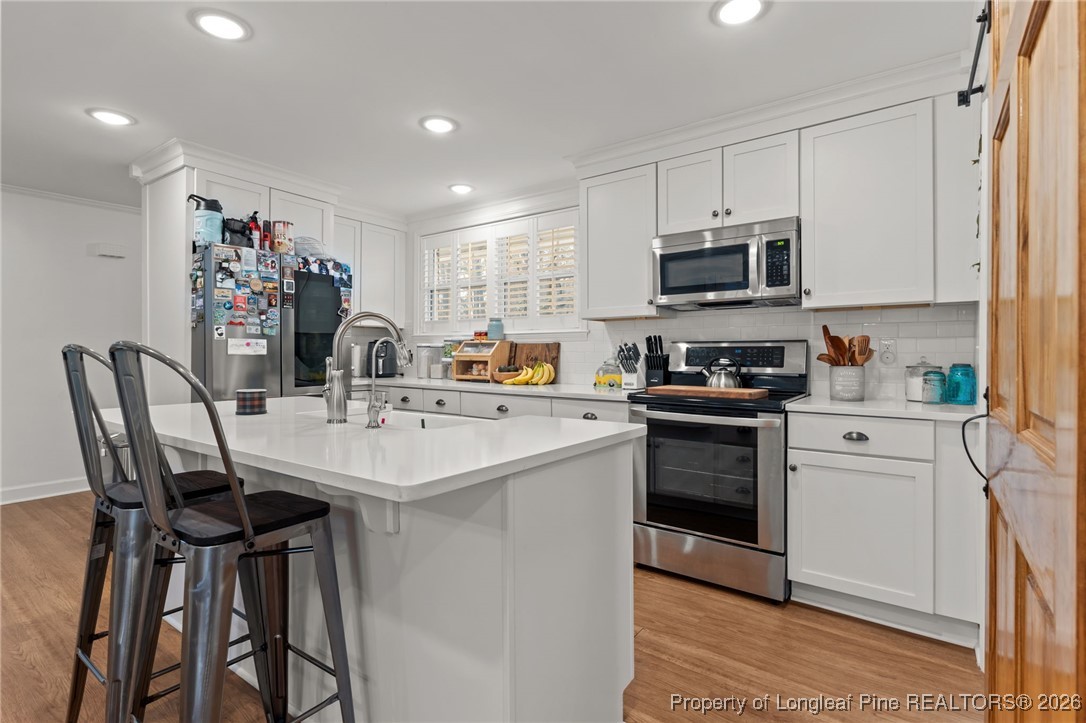 2060 Wade-Stedman Road Stedman, NC 28391 - Photo 9 of 41 a kitchen with stainless steel appliances a sink stove and refrigerator