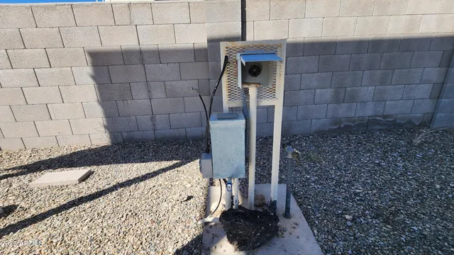 a backyard of a house with table and chairs
