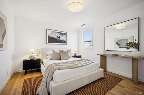 a bedroom with a bed and a mirror
