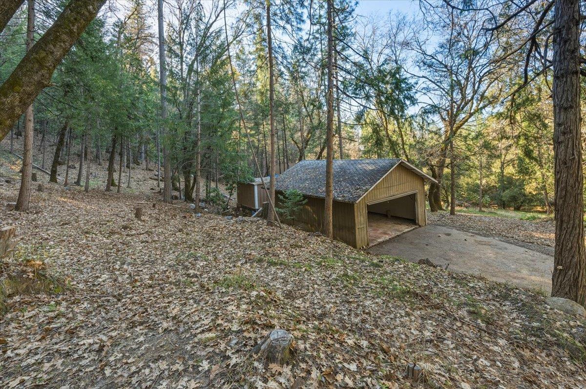 12056 North Bloomfield Road Nevada City, CA 95959 - Photo 14 of 50 a view of a house with a yard and hanging chair