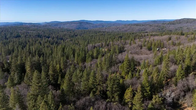 a stone house with trees in front of it