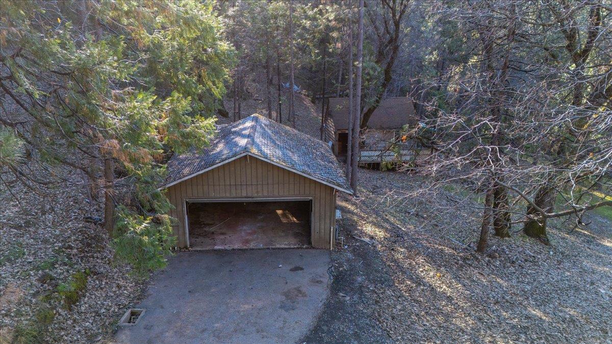 12056 North Bloomfield Road Nevada City, CA 95959 - Photo 38 of 50 a stone house with trees in front of it