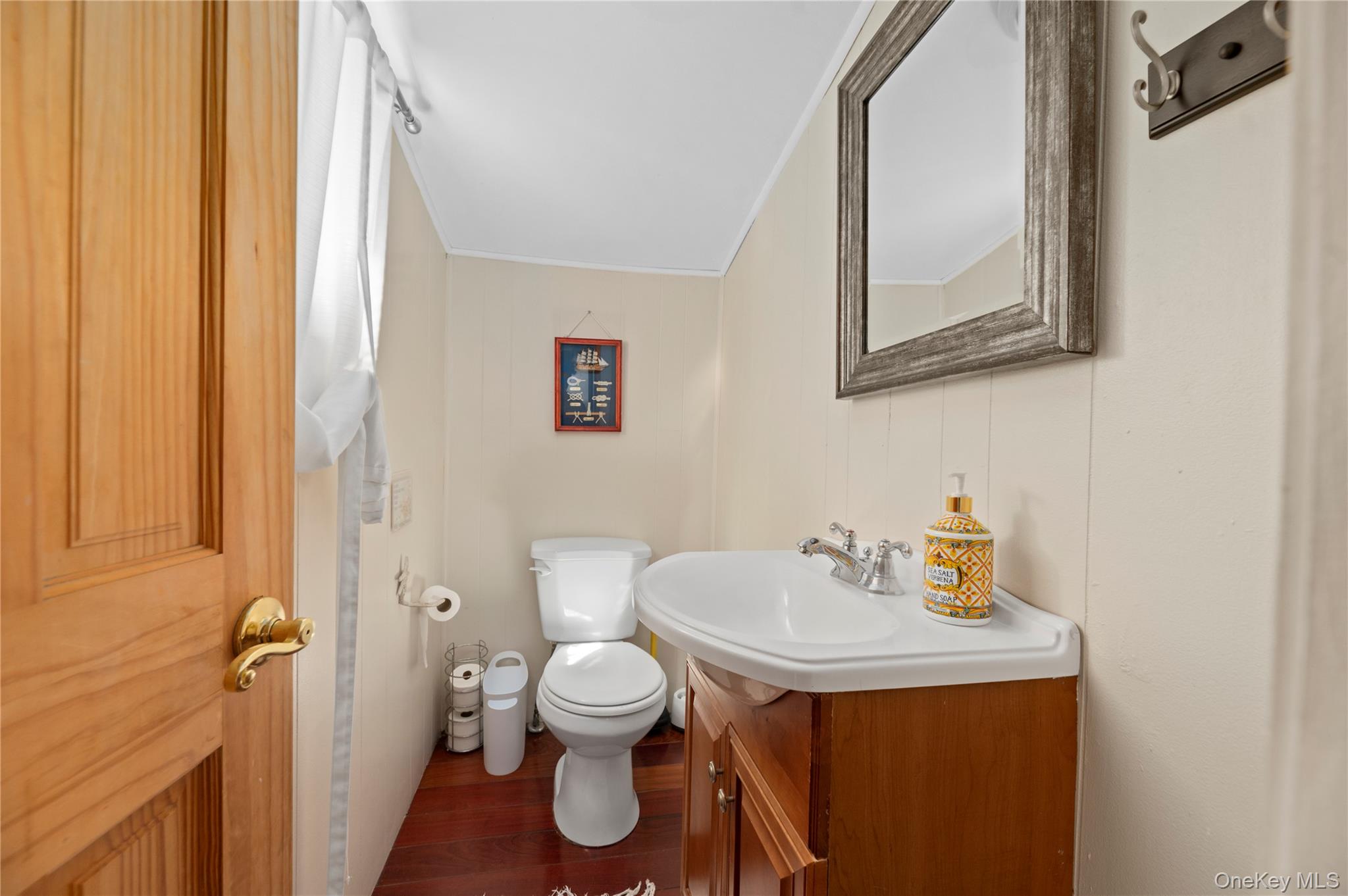 20 Seneca Walk Ocean Beach, NY 11770 - Photo 12 of 19 a bathroom with a toilet sink and mirror