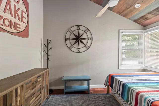 a bedroom with a bed a window and closet