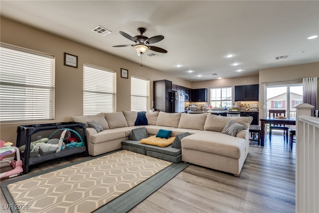 10519 Mann Street Las Vegas, NV 89141 - Photo 12 of 48 Living room with a ceiling fan, light wood-style flooring, and recessed lighting