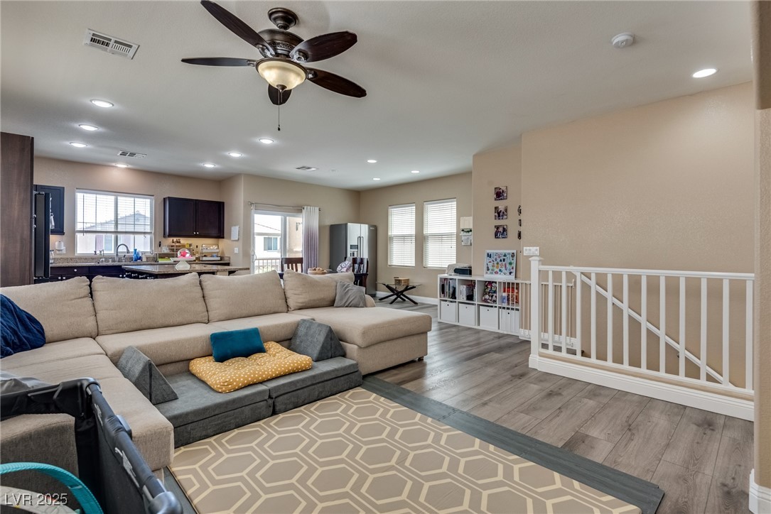 10519 Mann Street Las Vegas, NV 89141 - Photo 14 of 48 Living area with wood style finished floors, plenty of natural light, a ceiling fan, and recessed lighting