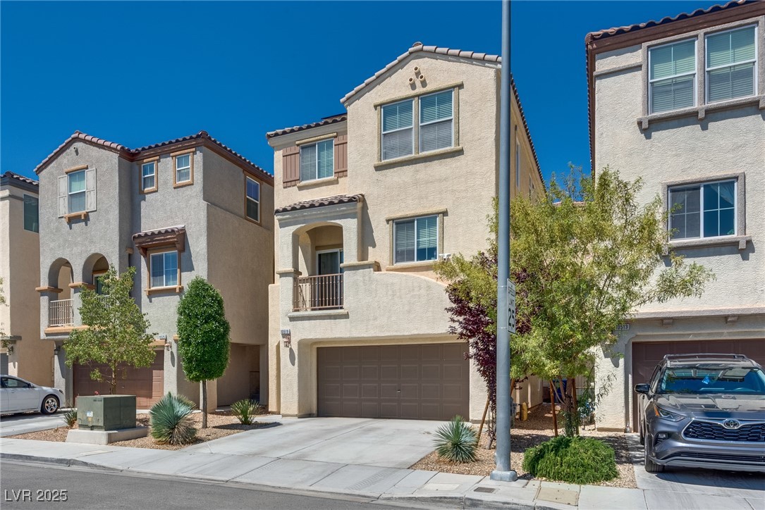 10519 Mann Street Las Vegas, NV 89141 - Photo 2 of 48 View of front of property featuring an attached garage, stucco siding, and concrete driveway