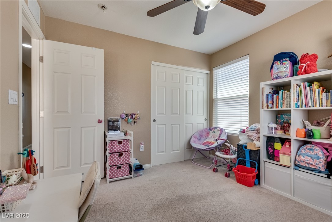 10519 Mann Street Las Vegas, NV 89141 - Photo 24 of 48 Bedroom with carpet, ceiling fan, and baseboards
