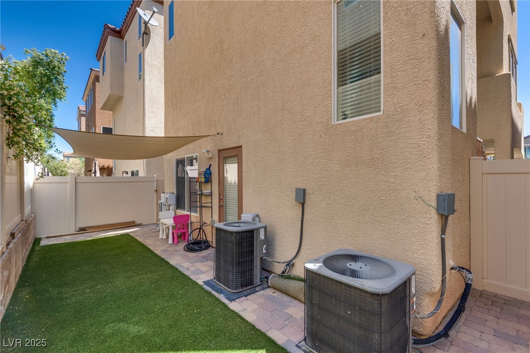 10519 Mann Street Las Vegas, NV 89141 - Photo 5 of 48 View of yard with cental AC unit and fence