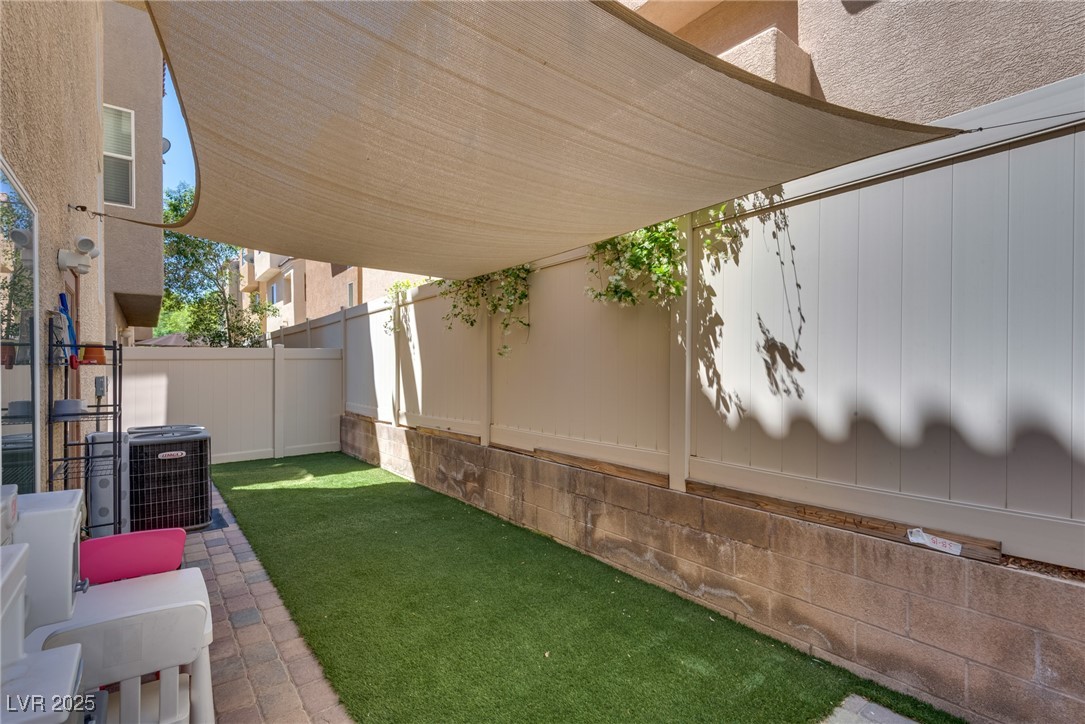10519 Mann Street Las Vegas, NV 89141 - Photo 7 of 48 View of yard featuring central air condition unit