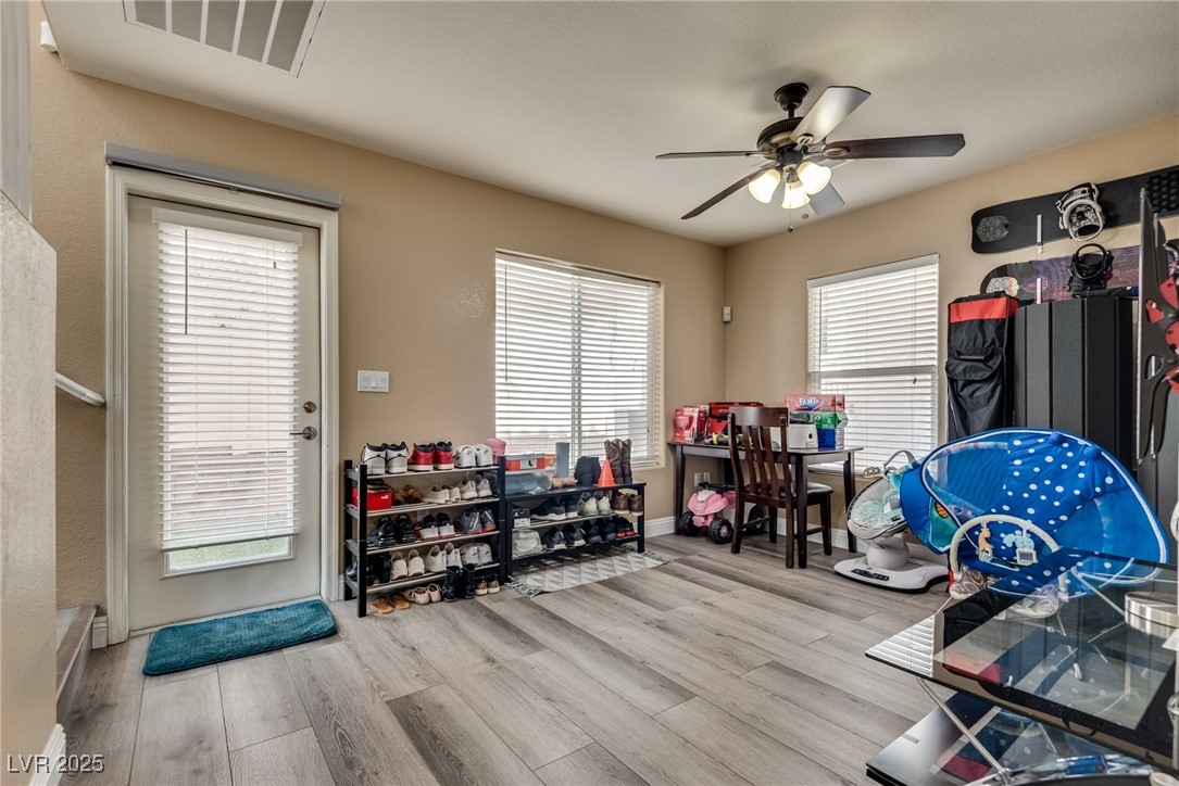 10519 Mann Street Las Vegas, NV 89141 - Photo 9 of 48 Playroom with wood finished floors, ceiling fan, plenty of natural light, and baseboards