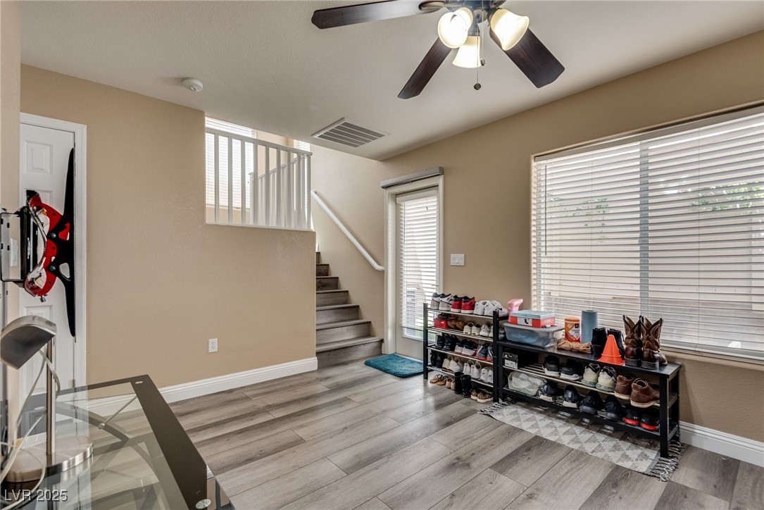 10519 Mann Street Las Vegas, NV 89141 - Photo 10 of 48 Downstairs den featuring ceiling fan, wood finished floors, and baseboards