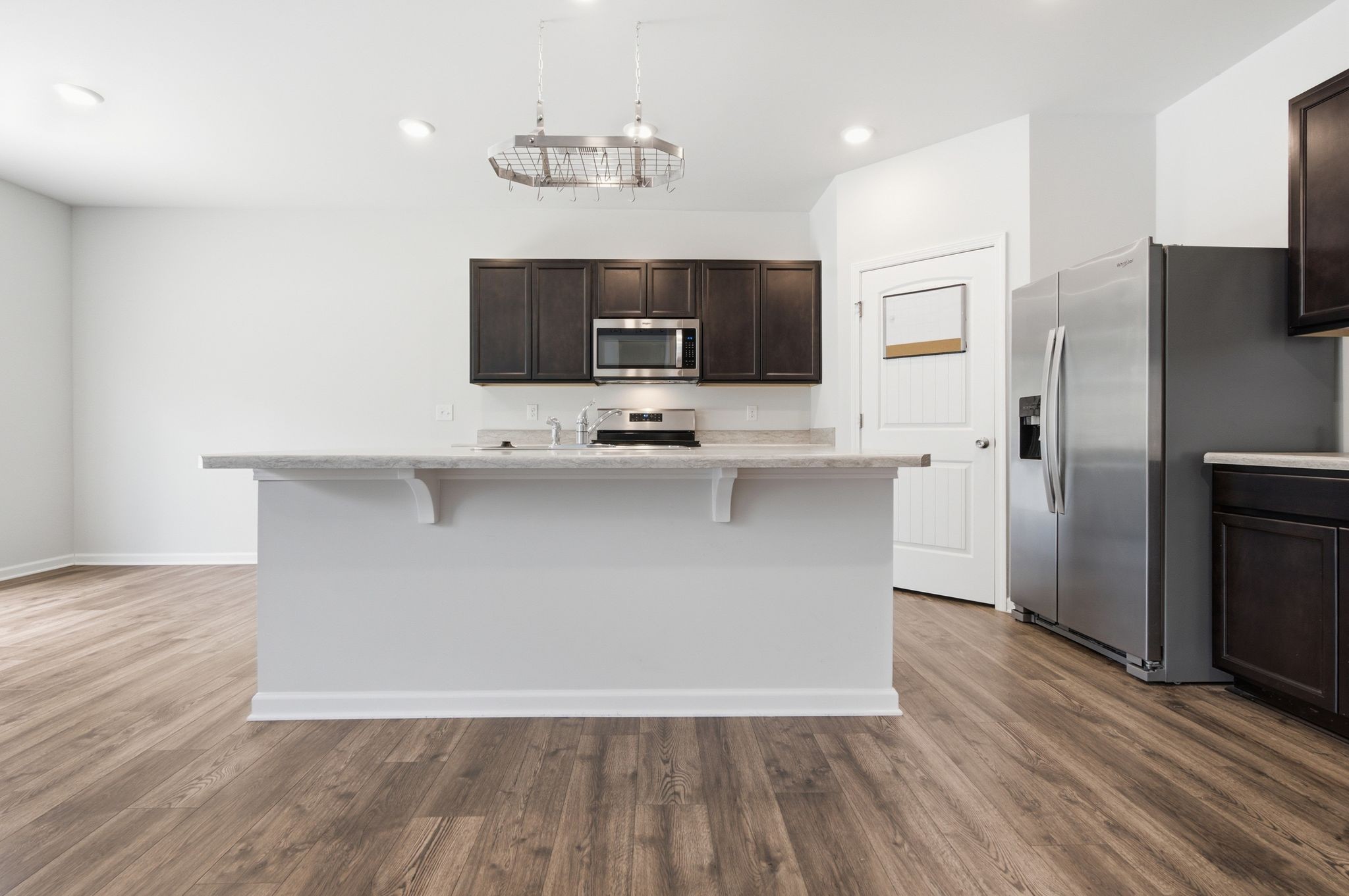 514 Ash Street Lebanon, TN 37087 - Photo 12 of 37 a living room with stainless steel appliances kitchen island a flat screen tv and a refrigerator