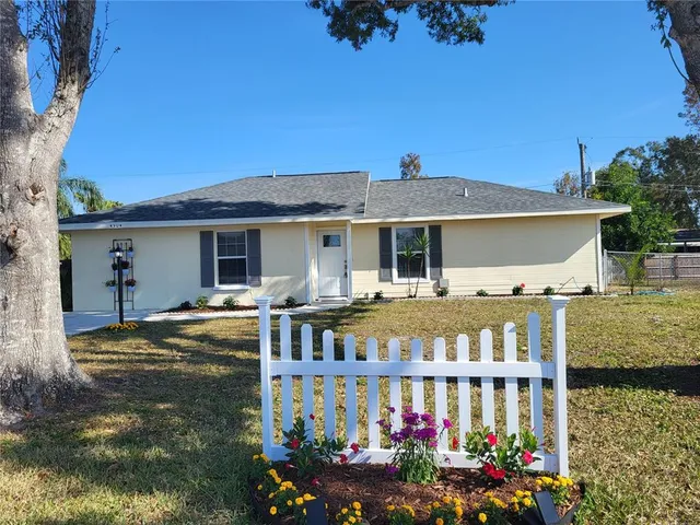 a front view of a house with a yard table and chairs