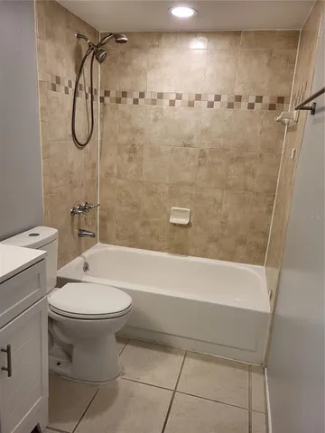 a bathroom with a toilet sink and shower