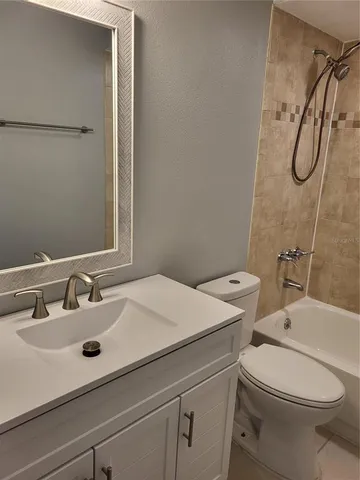 a bathroom with a sink mirror vanity and toilet