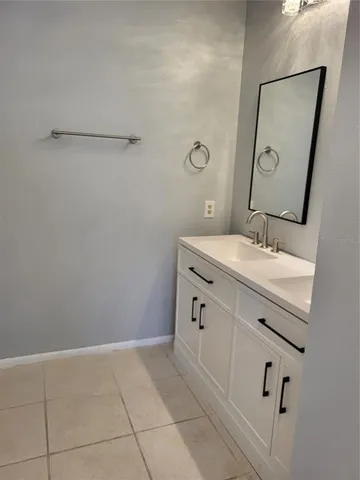 a bathroom with a sink a vanity and a mirror
