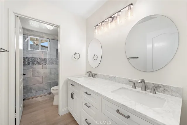 an empty room with wooden floor and window