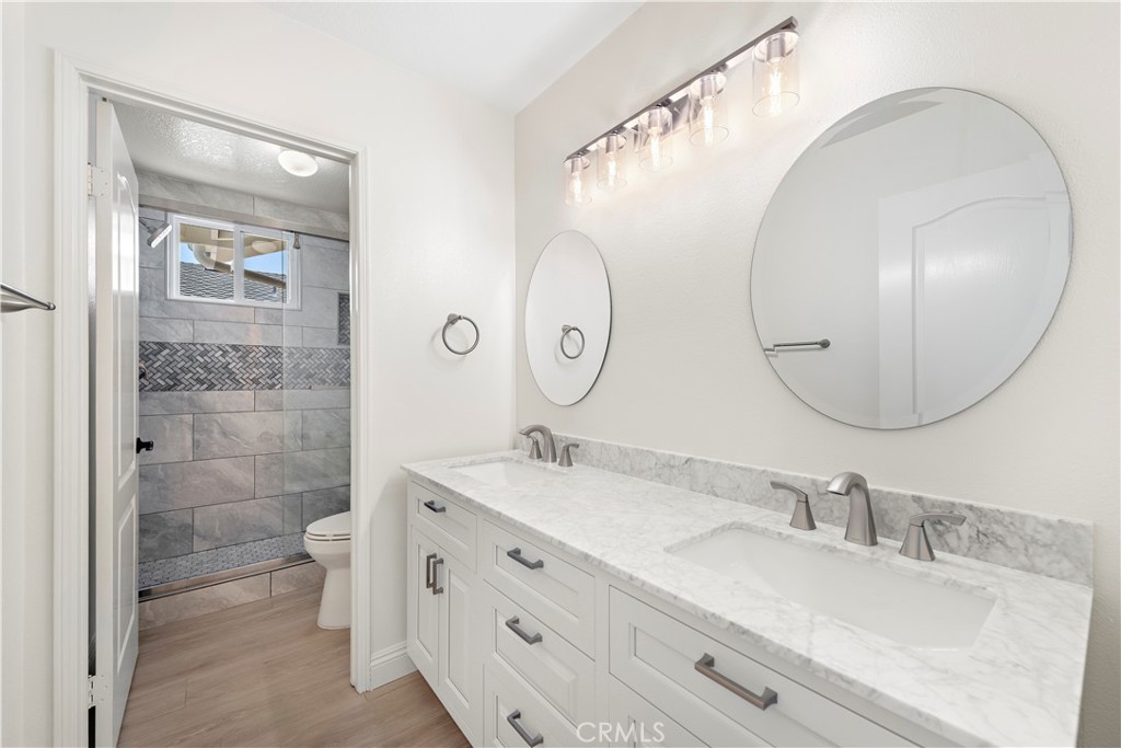8 Via Jazmin San Clemente, CA 92672 - Photo 13 of 25 a bathroom with a double vanity sink mirror and toilet