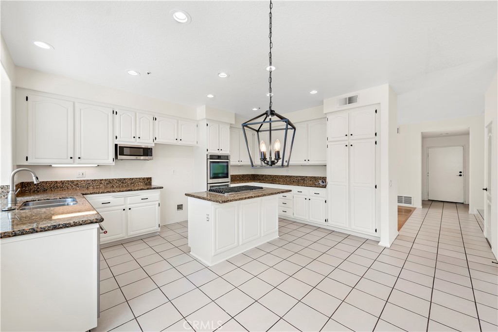 8 Via Jazmin San Clemente, CA 92672 - Photo 4 of 25 a kitchen with a stove a sink and a refrigerator