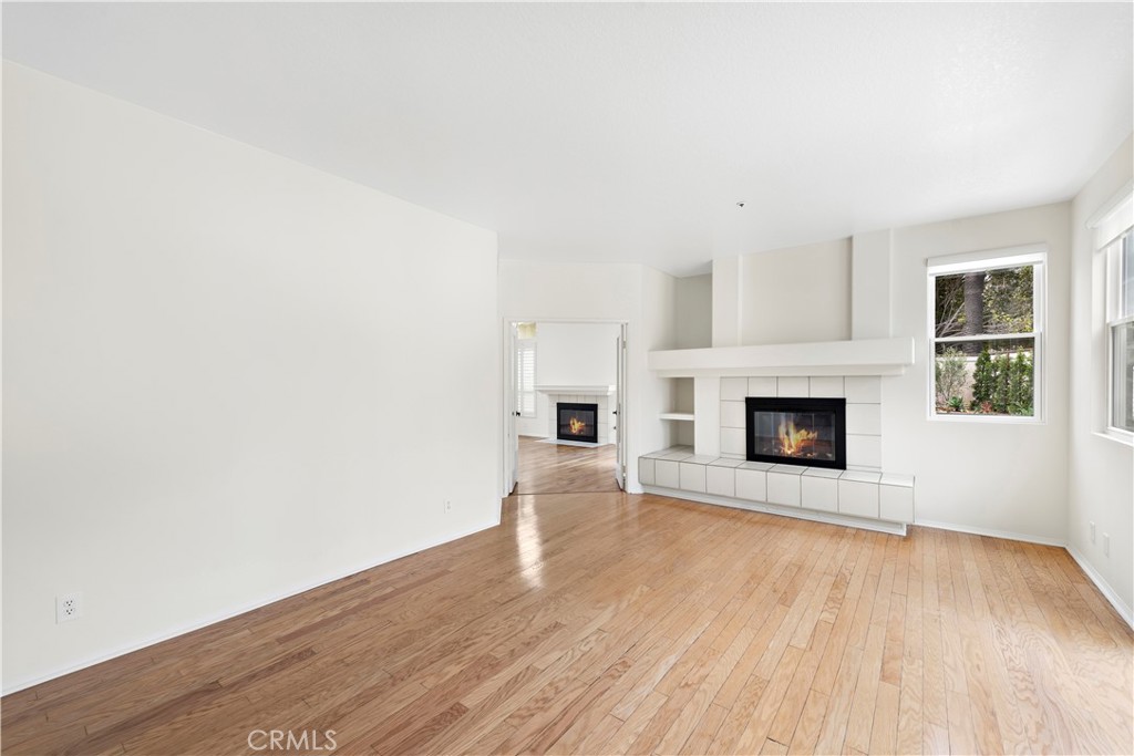 8 Via Jazmin San Clemente, CA 92672 - Photo 8 of 25 a view of empty room with wooden floor and fireplace