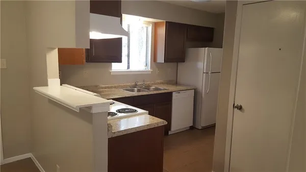 a kitchen with a refrigerator and a sink